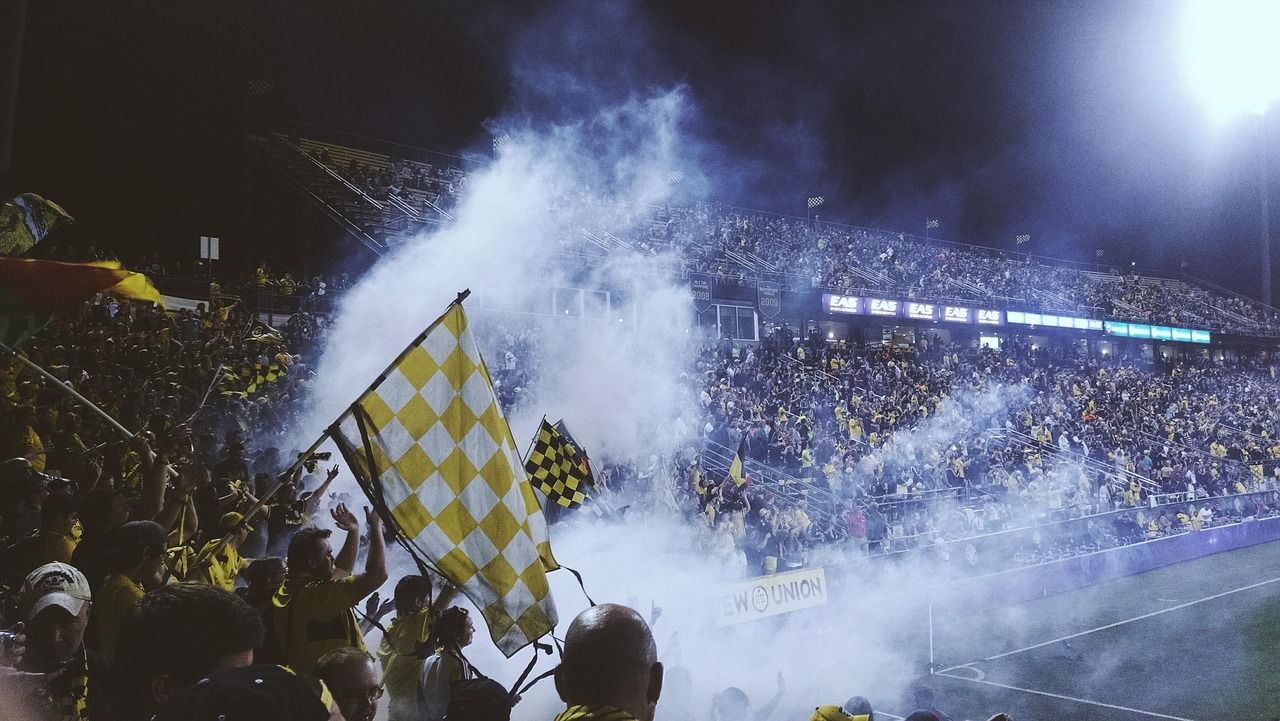 soccer stadium floodlights night match crowd no team crest