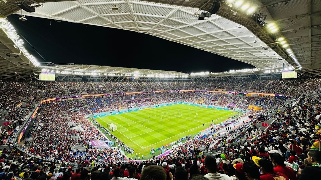 soccer stadium floodlights night match crowd no team crest