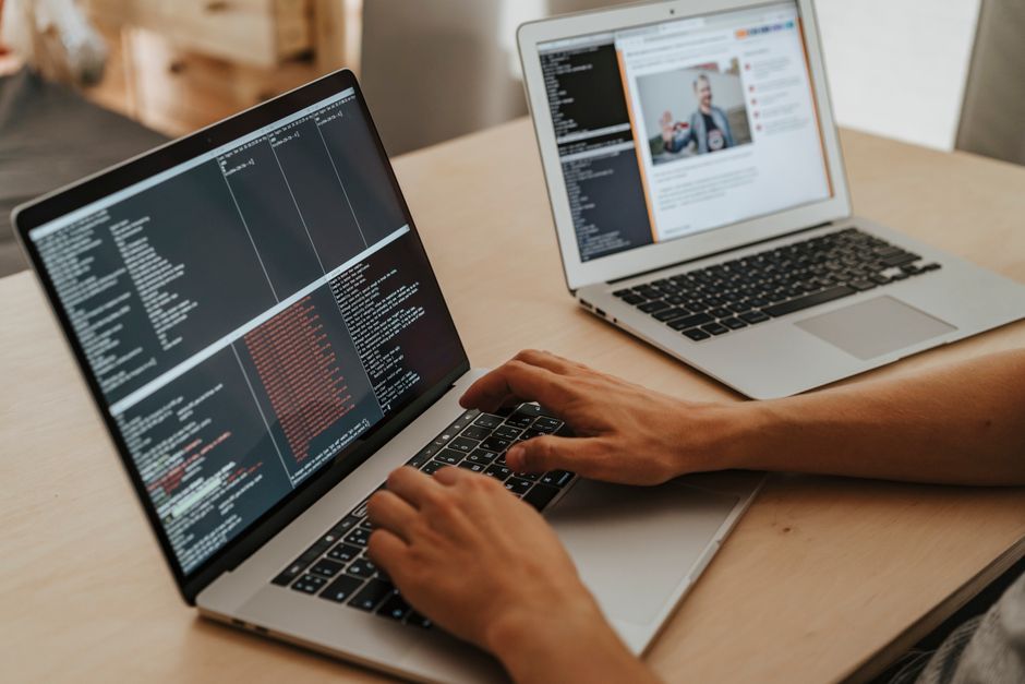 software developer working on laptop office desk