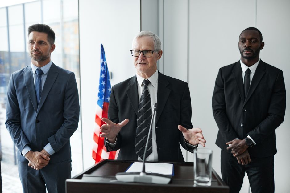 British politicians speaking at podium press conference