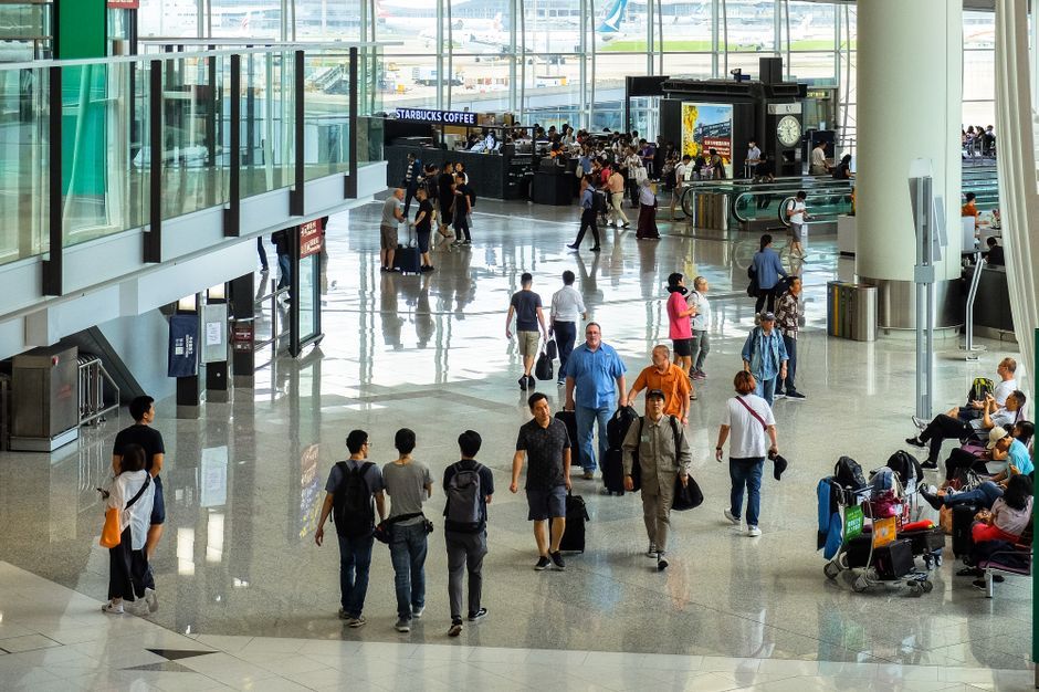 busy airport terminal delayed flights crowd passengers