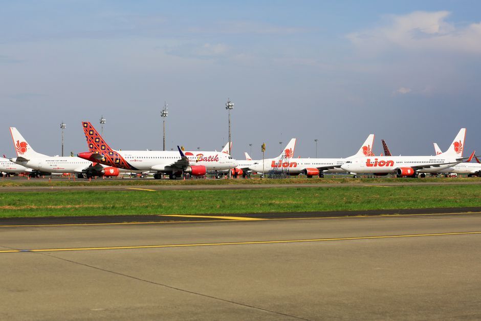 commercial airplane airport runway daytime no logo