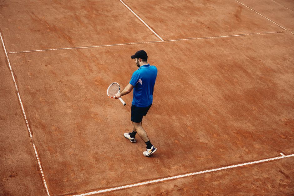 professional tennis player celebrating match victory on court