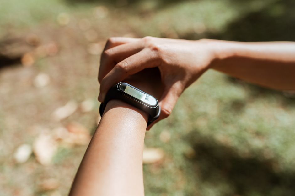 person checking fitness tracker smartwatch health data screen