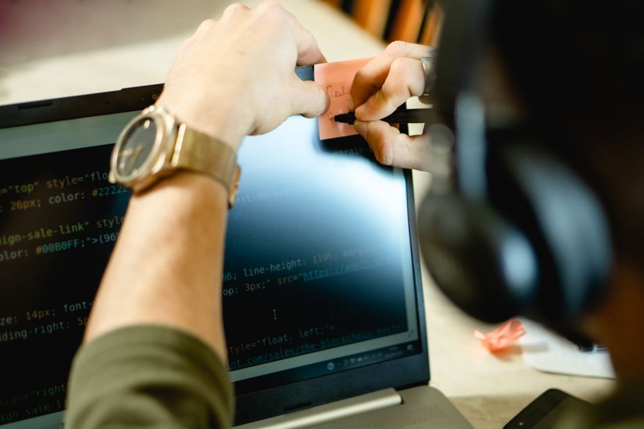 programmer developer writing code workspace laptop